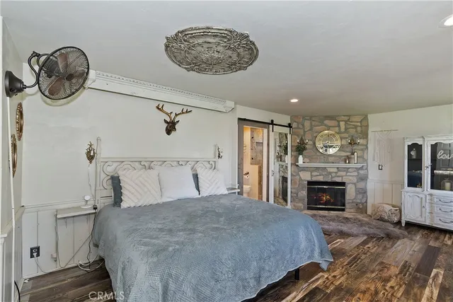 a bedroom with a bed and a fireplace