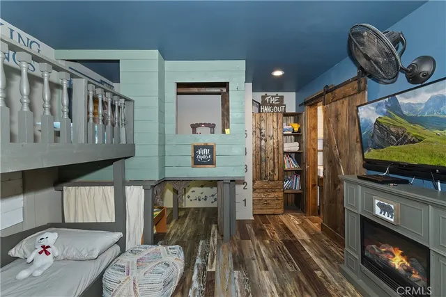 a view of a hallway with wooden floor and furniture