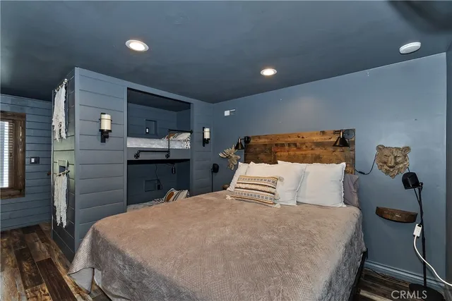 a bedroom with a bed and a large mirror