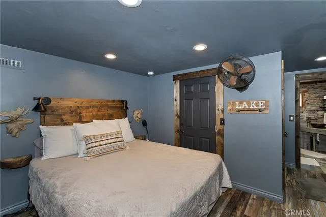 a bedroom with a bed and cabinets