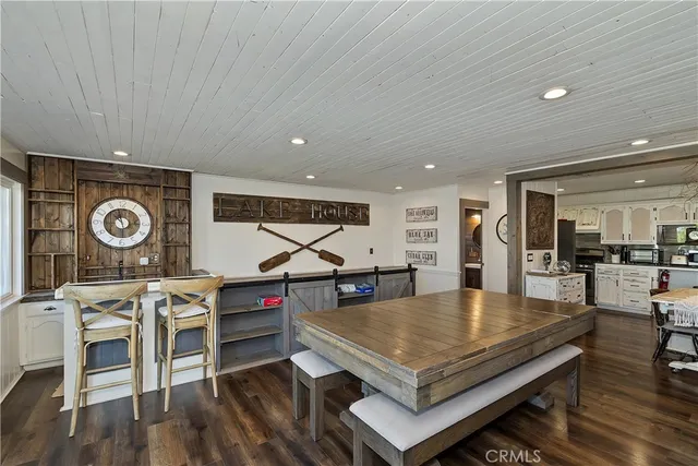 a living room with furniture a rug and kitchen view