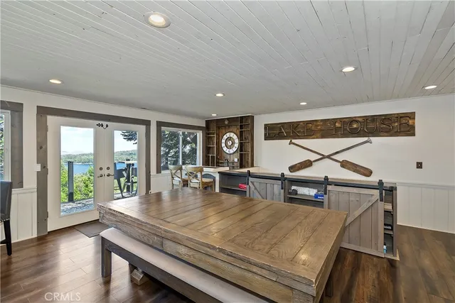 a living room with furniture a table and wooden floor