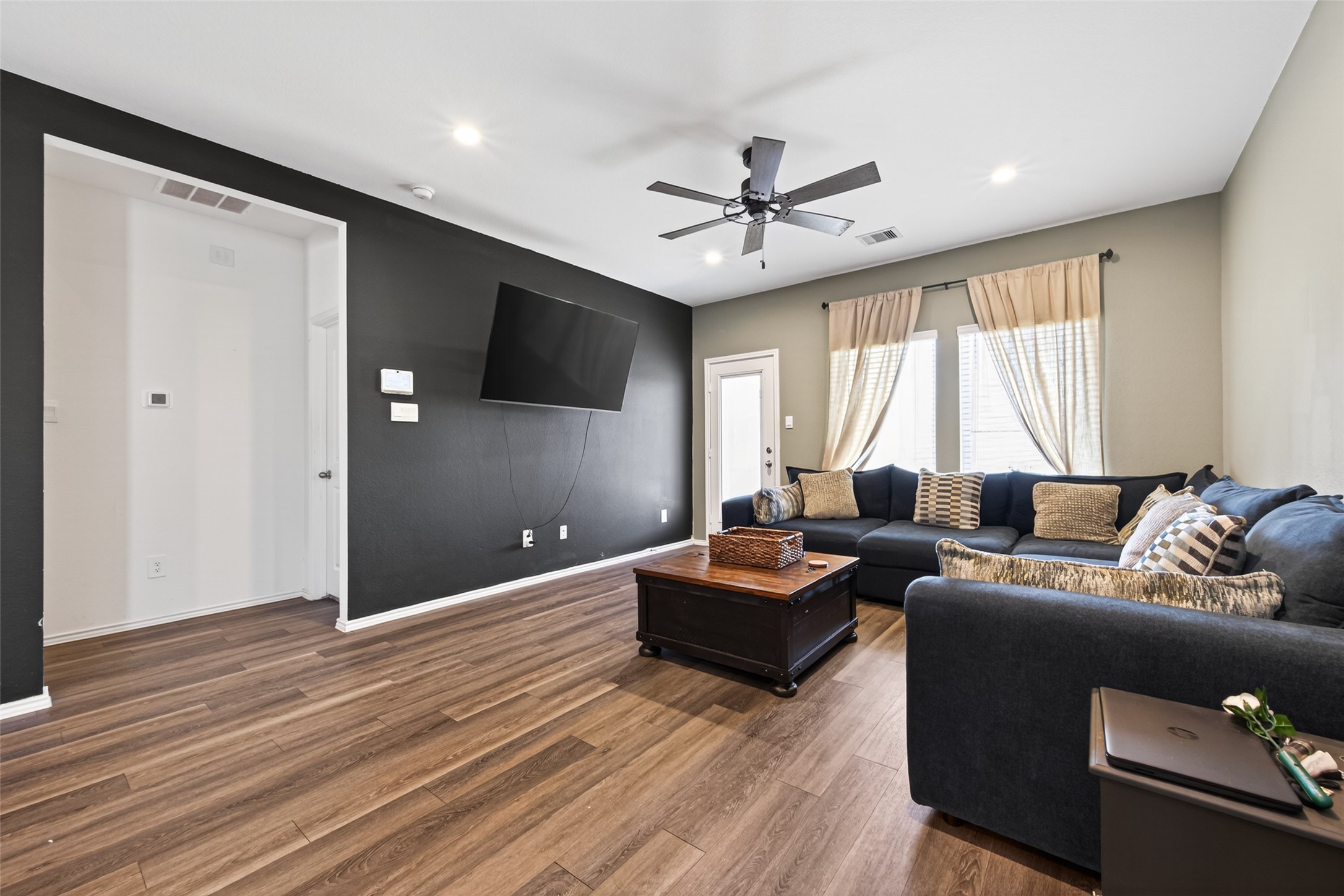 24251 Copperleaf Bay Ln Spring Spring, TX 77373 - Photo 12 of 42 a living room with couches a coffee table and a flat screen tv