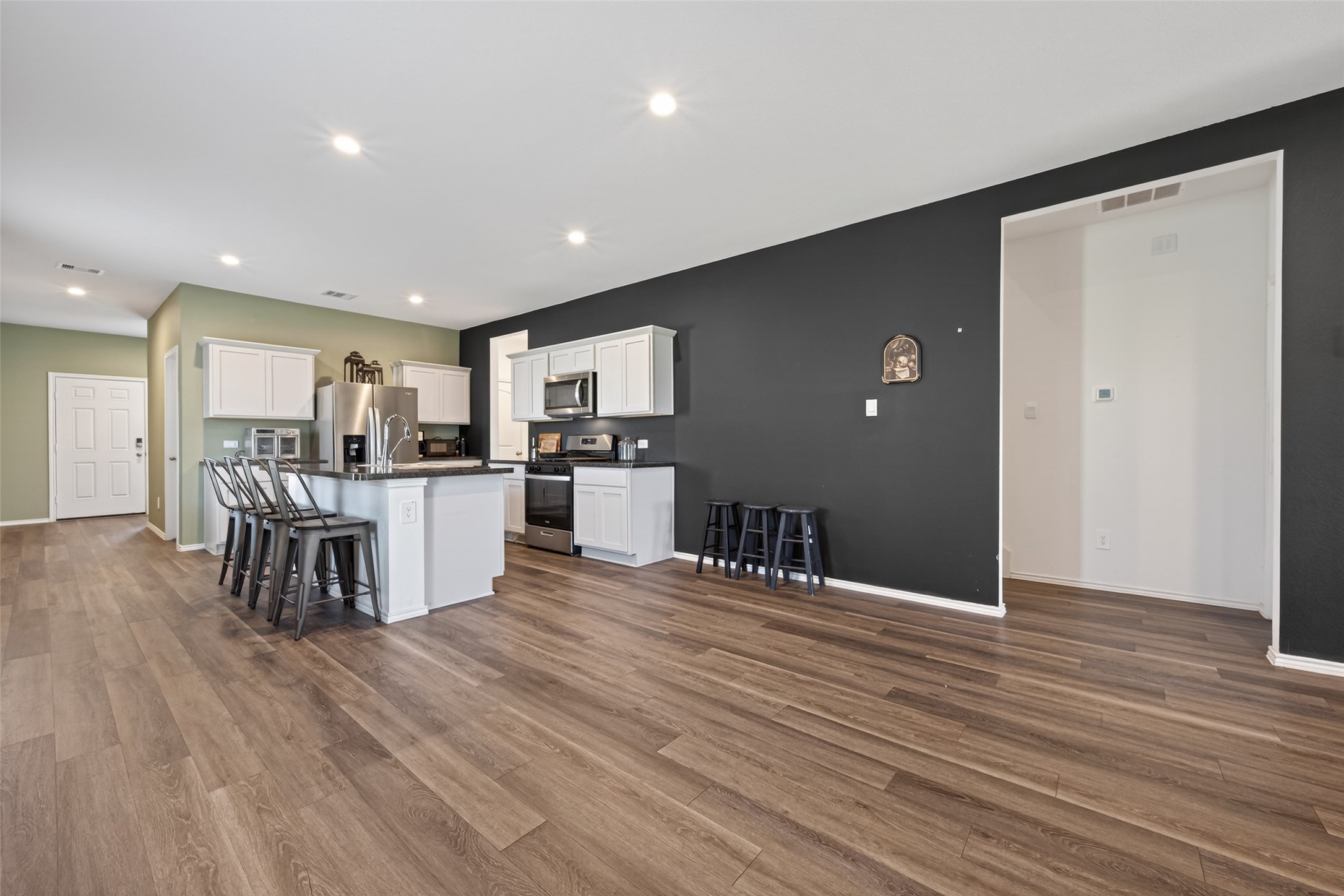 24251 Copperleaf Bay Ln Spring Spring, TX 77373 - Photo 13 of 42 a kitchen with stainless steel appliances kitchen island granite countertop a refrigerator and a stove top oven