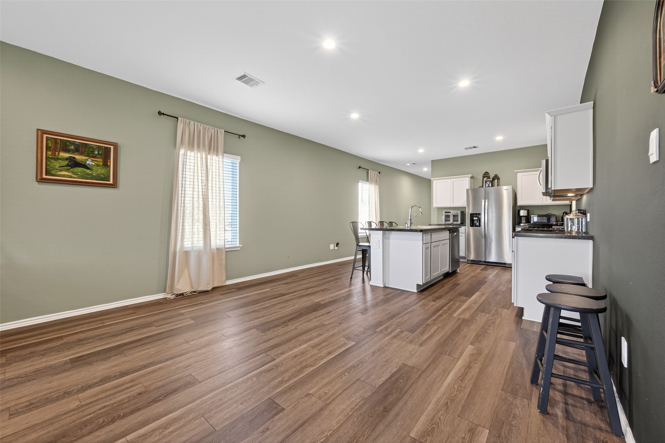 24251 Copperleaf Bay Ln Spring Spring, TX 77373 - Photo 14 of 42 a view of a kitchen with wooden floor and electronic appliances