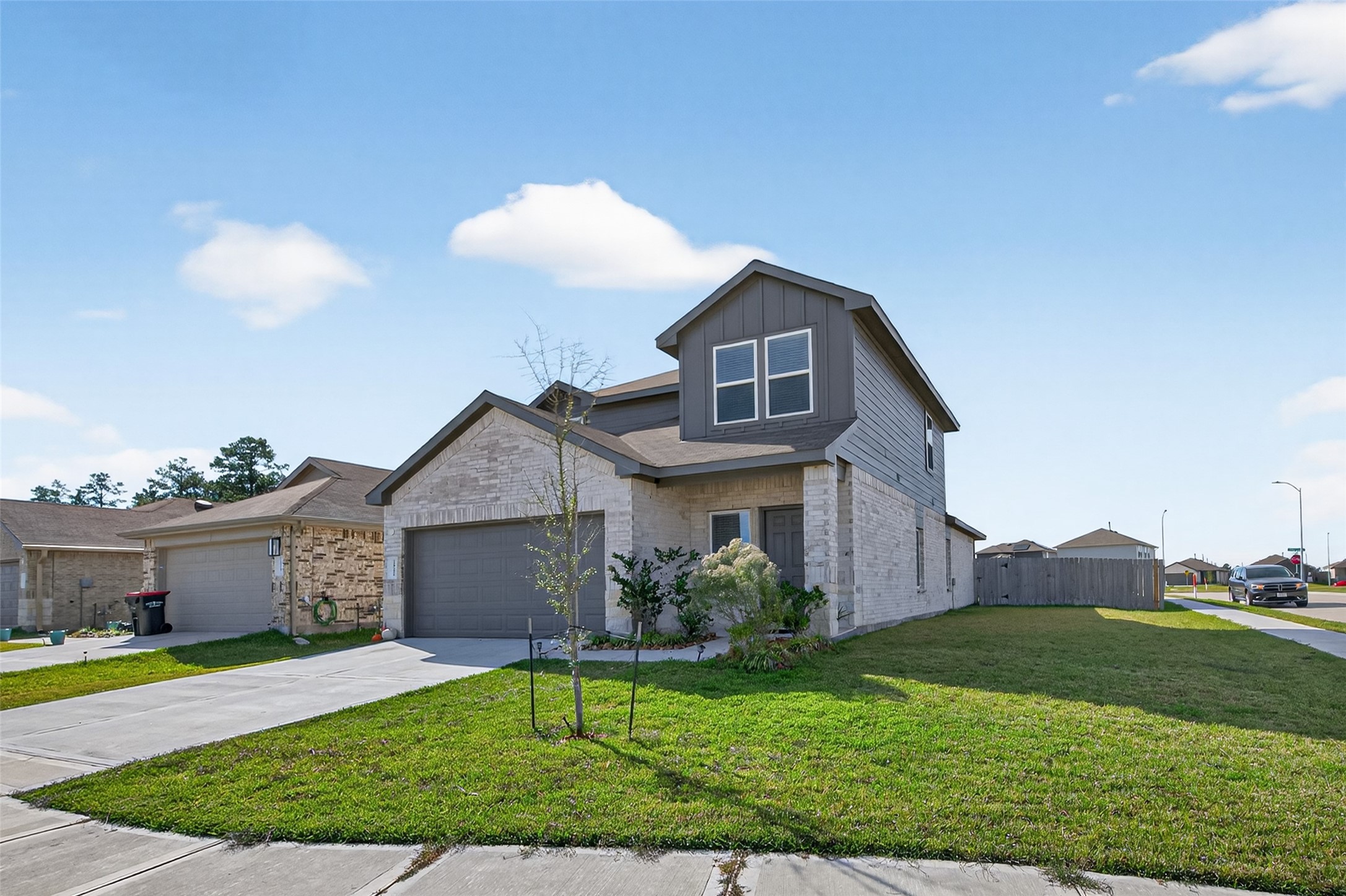 24251 Copperleaf Bay Ln Spring Spring, TX 77373 - Photo 2 of 42 a front view of a house with a garden and plants