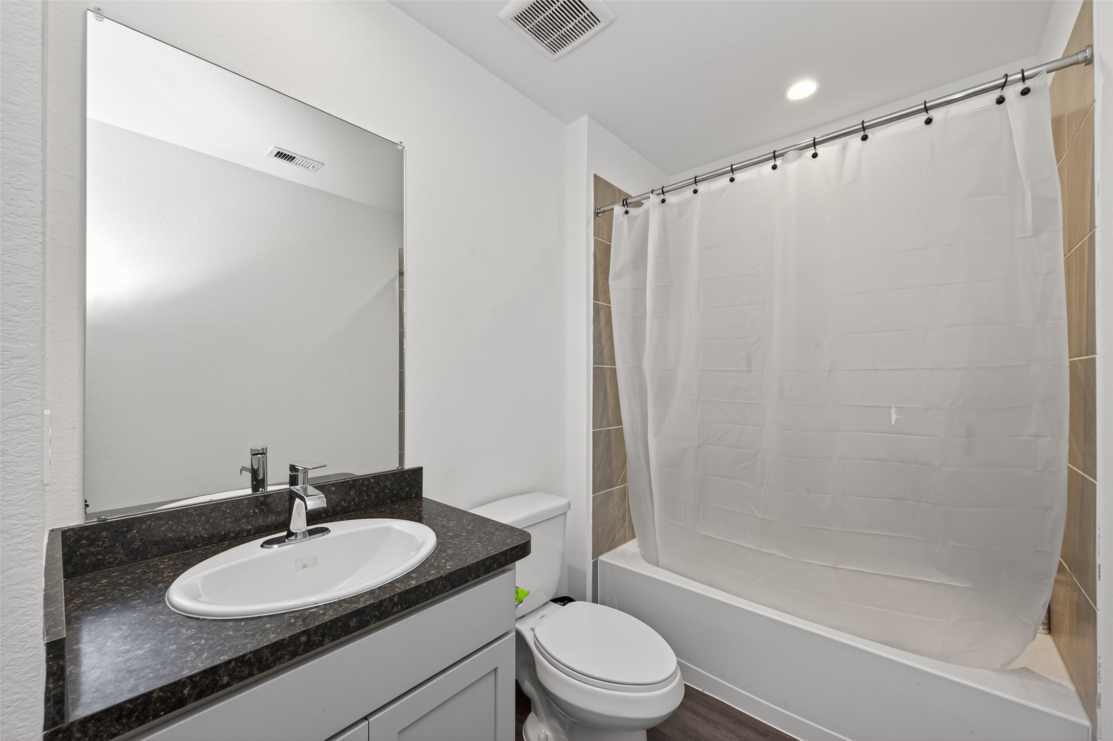 24251 Copperleaf Bay Ln Spring Spring, TX 77373 - Photo 32 of 42 a bathroom with a sink a toilet and a mirror