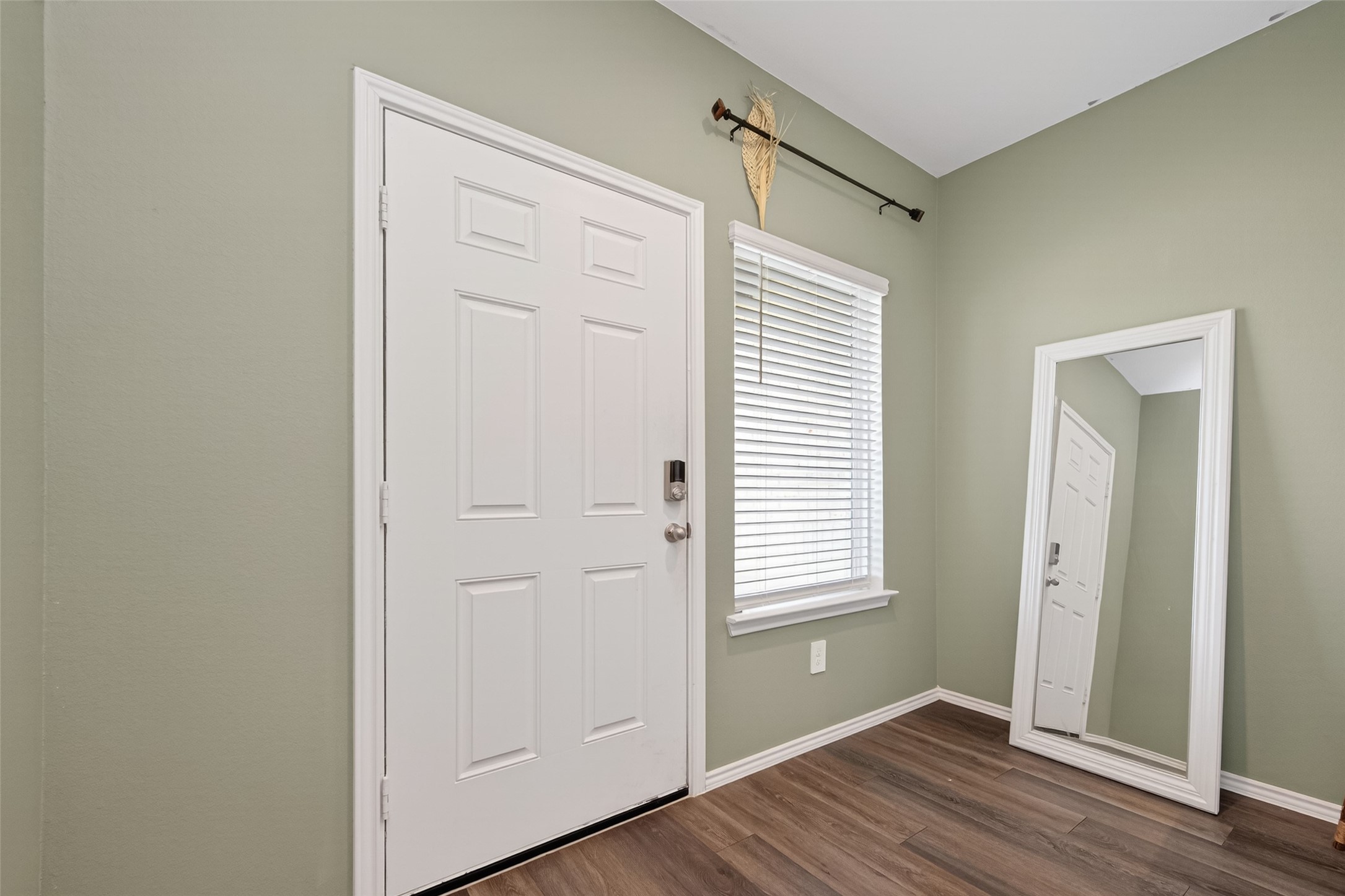 24251 Copperleaf Bay Ln Spring Spring, TX 77373 - Photo 4 of 42 a view of an empty room with wooden floor and a window