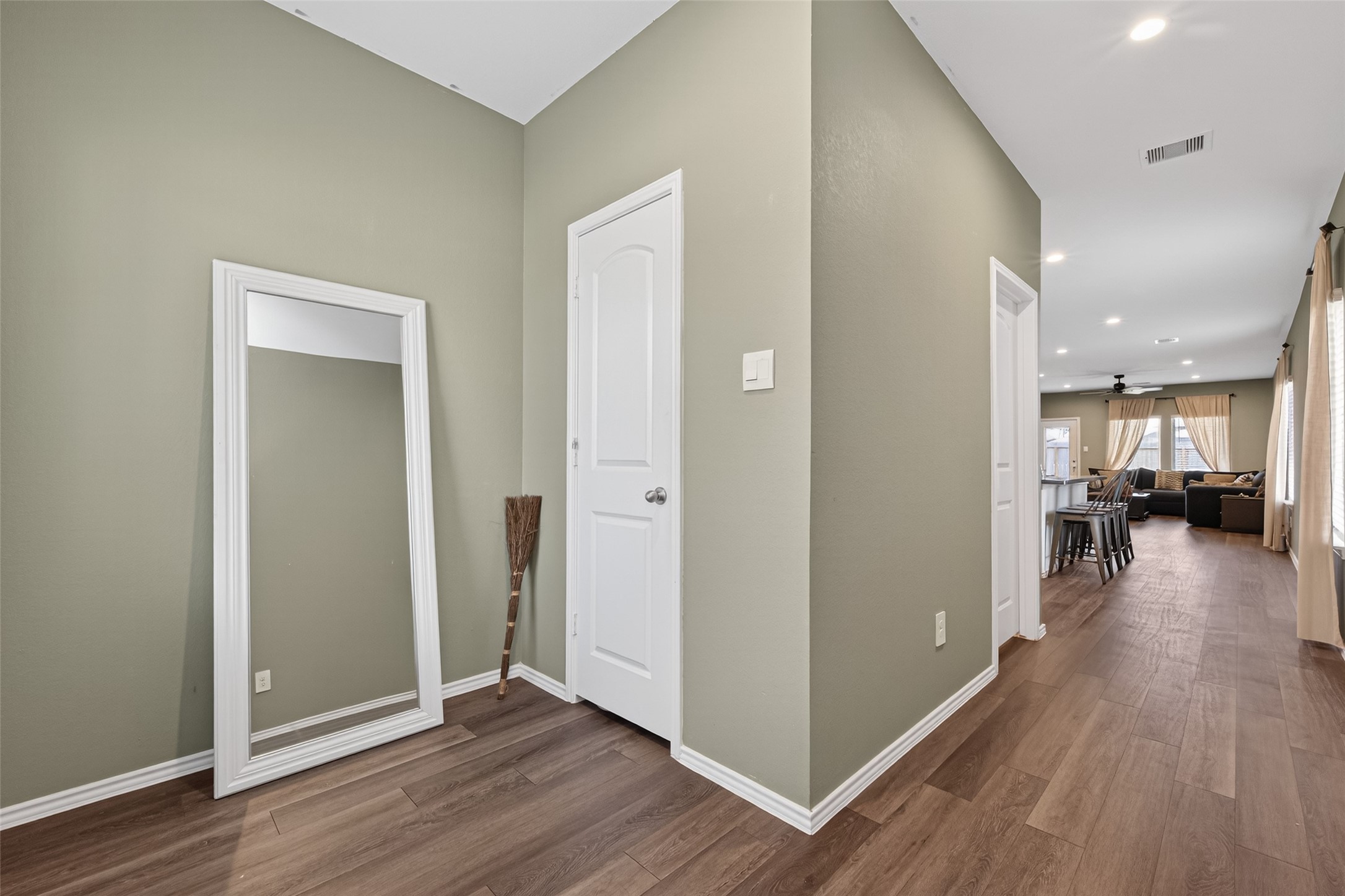 24251 Copperleaf Bay Ln Spring Spring, TX 77373 - Photo 5 of 42 a view of a hallway view with wooden floor and a living room