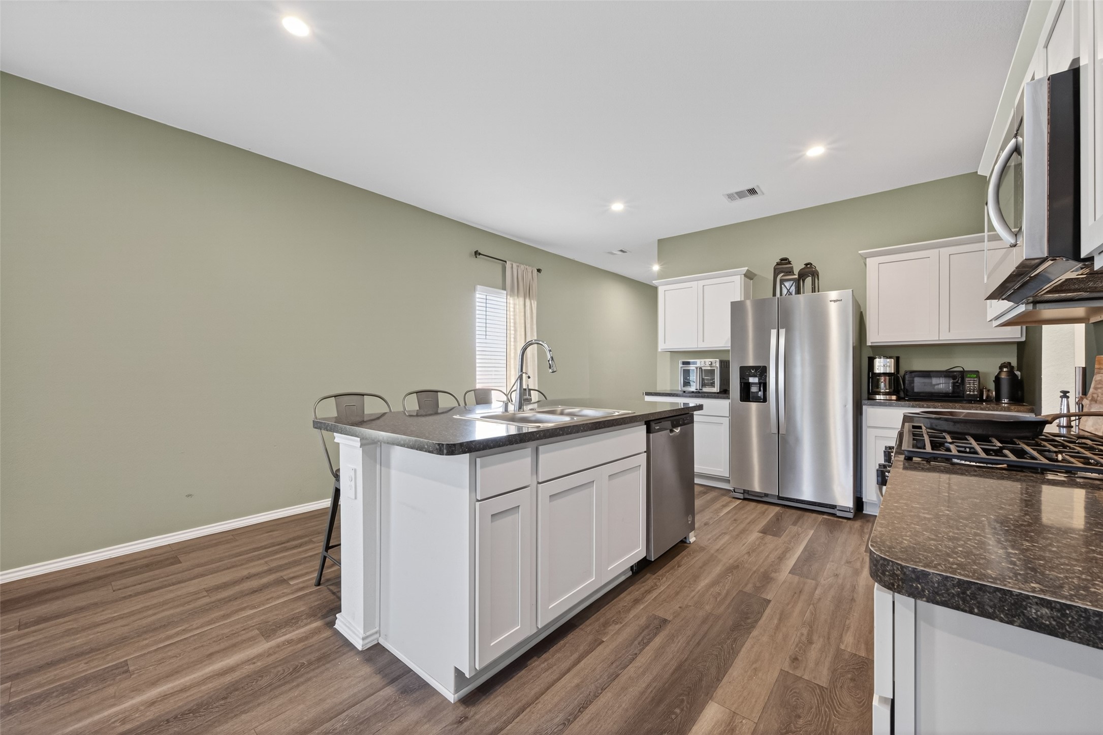 24251 Copperleaf Bay Ln Spring Spring, TX 77373 - Photo 8 of 42 a kitchen with stainless steel appliances granite countertop a sink stove and refrigerator