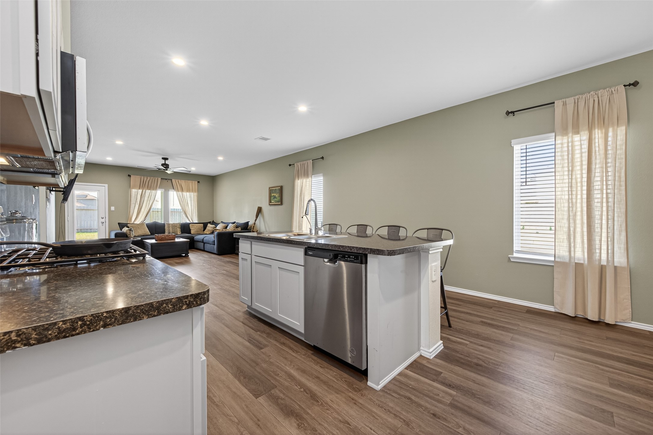 24251 Copperleaf Bay Ln Spring Spring, TX 77373 - Photo 9 of 42 a kitchen with stainless steel appliances granite countertop a sink a stove and a wooden floors