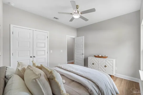 a bedroom with a bed and a chandelier