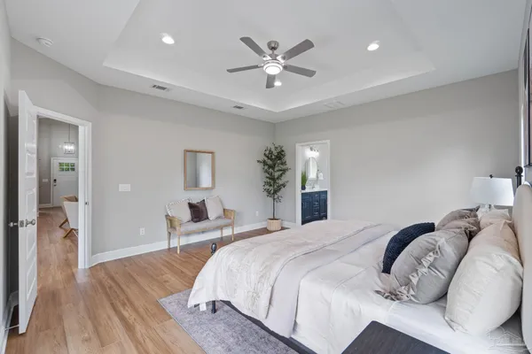 a bedroom with a large bed and a chandelier