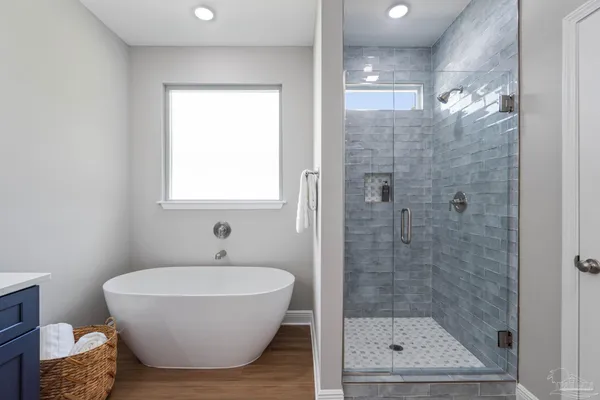 a bathroom with a bathtub and shower