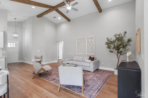 a living room with furniture and a potted plant