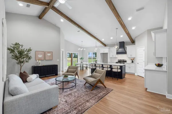 a living room with fireplace furniture and a wooden floor