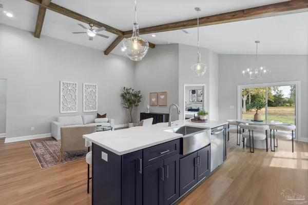 a large kitchen with a table and chairs