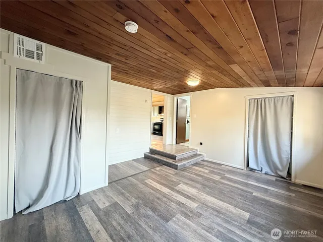 a view of a room with wooden floor and window