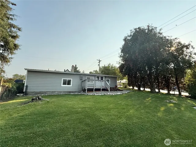 a view of a house with a yard and sitting area