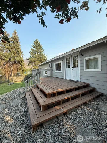 a view of a wooden chairs in a backyard