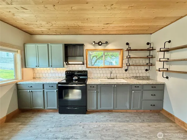 a kitchen with stainless steel appliances granite countertop a sink and cabinets