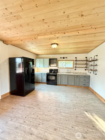 a view of a kitchen with cabinets and stainless steel appliances