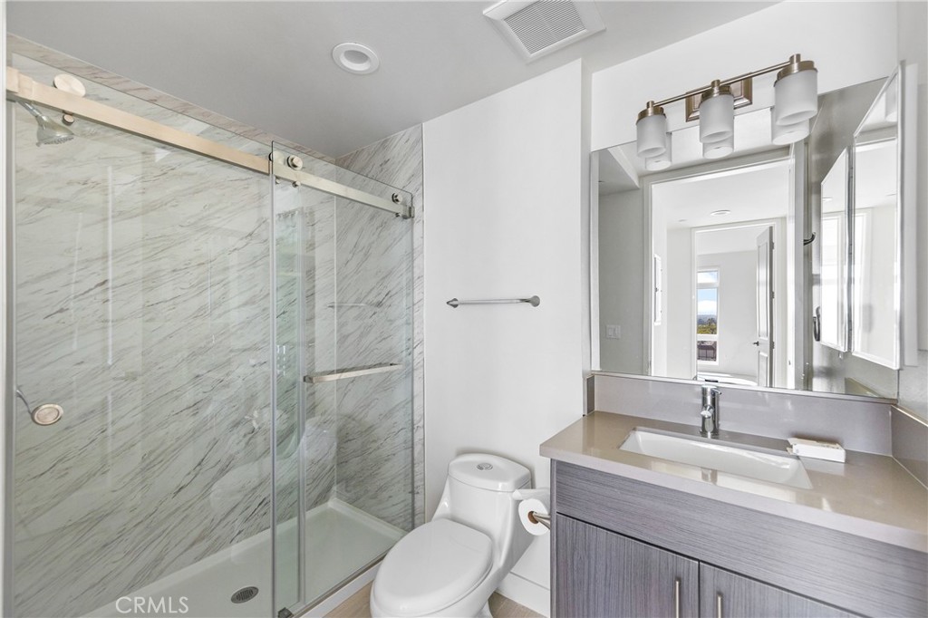 168 South Monterey Street, Unit 518 Alhambra, CA 91801 - Photo 14 of 45 a bathroom with a granite countertop sink toilet a mirror and shower
