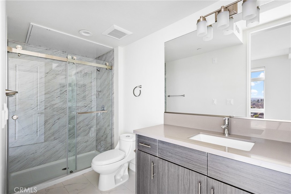 168 South Monterey Street, Unit 518 Alhambra, CA 91801 - Photo 21 of 45 a bathroom with a granite countertop sink toilet and shower