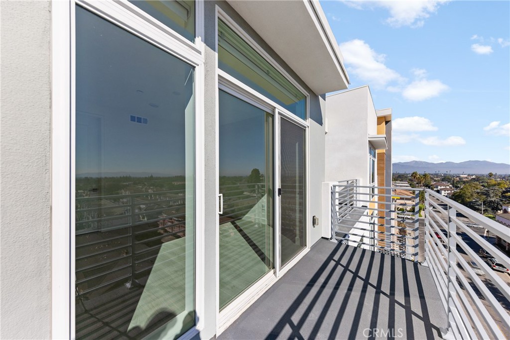 168 South Monterey Street, Unit 518 Alhambra, CA 91801 - Photo 23 of 45 a view of a balcony with floor to ceiling windows with wooden floor