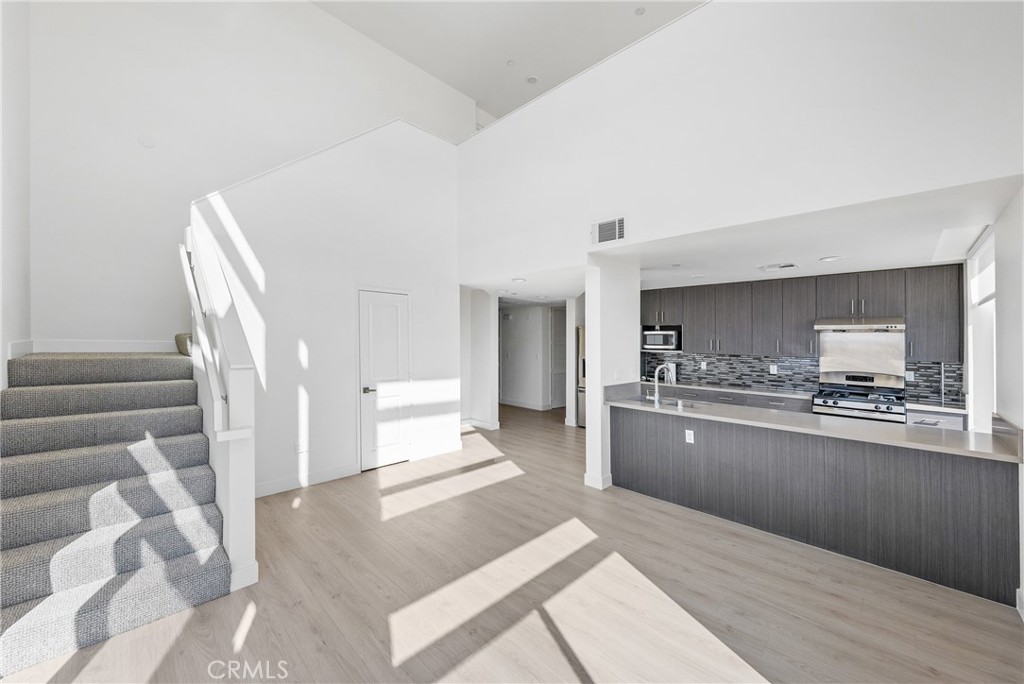 168 South Monterey Street, Unit 518 Alhambra, CA 91801 - Photo 4 of 45 a kitchen with stainless steel appliances granite countertop a stove a sink and a refrigerator