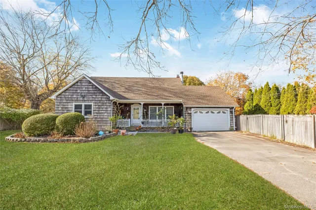 a view of a house with a yard and sitting area