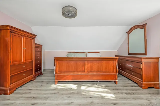 a bedroom with a bed and dresser