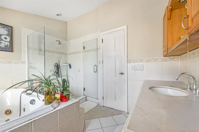 a living room with furniture and a refrigerator