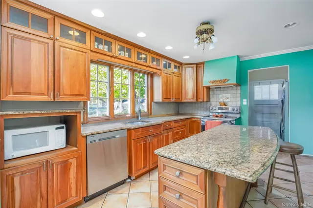 a kitchen with stainless steel appliances granite countertop a sink and cabinets