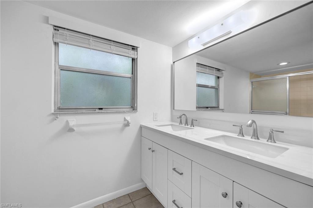 3200 Binnacle Drive, Unit B4 Naples, FL 34103 - Photo 11 of 25 a bathroom with 2 sink and a mirror
