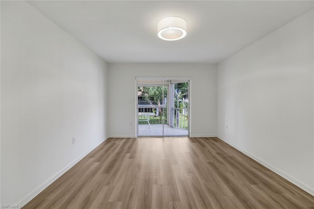 3200 Binnacle Drive, Unit B4 Naples, FL 34103 - Photo 13 of 25 an empty room with wooden floor and windows