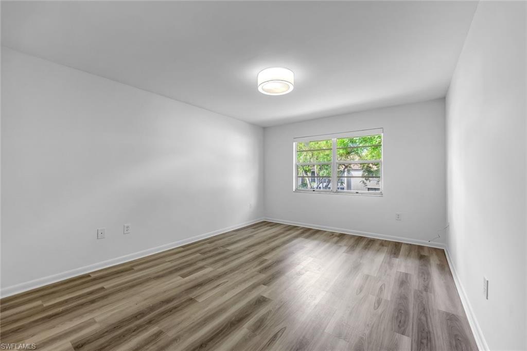 3200 Binnacle Drive, Unit B4 Naples, FL 34103 - Photo 14 of 25 an empty room with wooden floor and windows