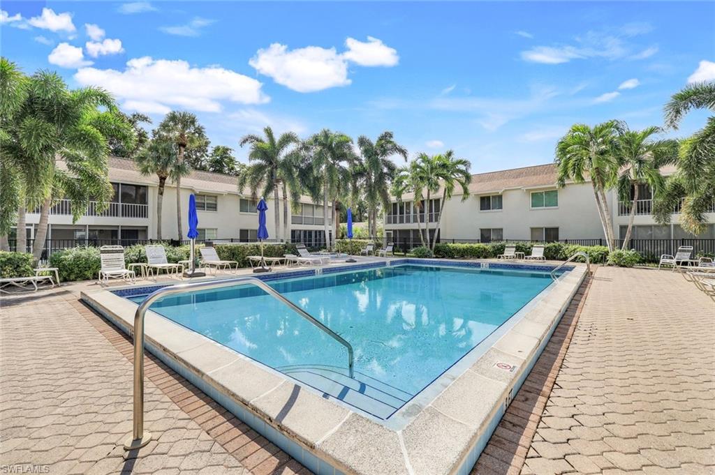 3200 Binnacle Drive, Unit B4 Naples, FL 34103 - Photo 20 of 25 a view of swimming pool with outdoor seating and house in the background