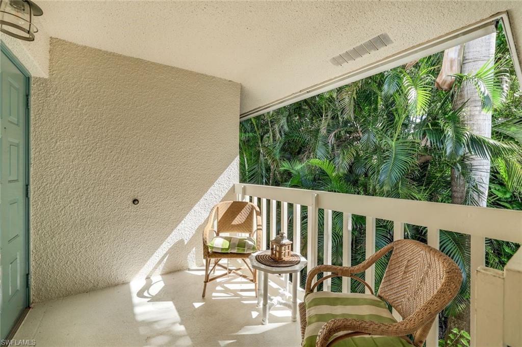 3200 Binnacle Drive, Unit B4 Naples, FL 34103 - Photo 2 of 25 a balcony with wooden floor stairs and furniture