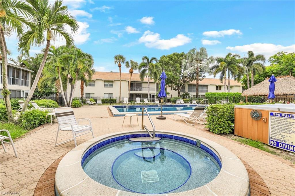 3200 Binnacle Drive, Unit B4 Naples, FL 34103 - Photo 21 of 25 a swimming pool with outdoor seating and yard