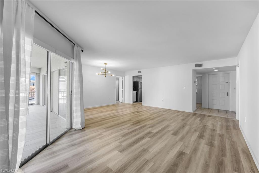 3200 Binnacle Drive, Unit B4 Naples, FL 34103 - Photo 7 of 25 a view of empty room with wooden floor
