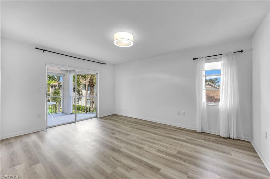 3200 Binnacle Drive, Unit B4 Naples, FL 34103 - Photo 9 of 25 an empty room with wooden floor and windows