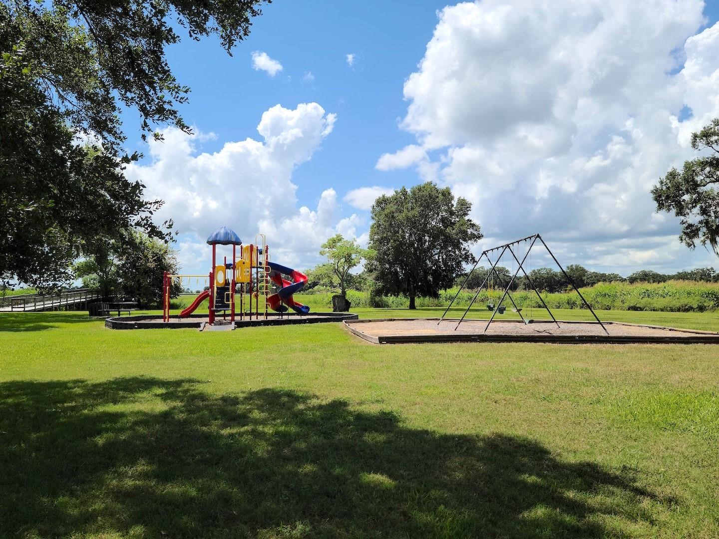 912 Wagon Wheel Trail Angleton, TX 77515 - Photo 2 of 11 a view of a lake and houses in the back