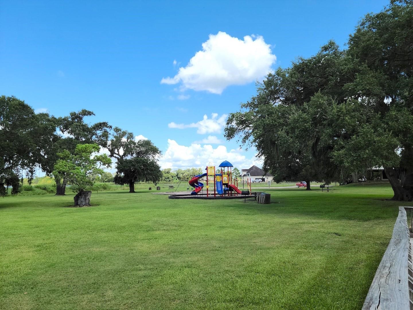 912 Wagon Wheel Trail Angleton, TX 77515 - Photo 4 of 11 a view of a park with large trees