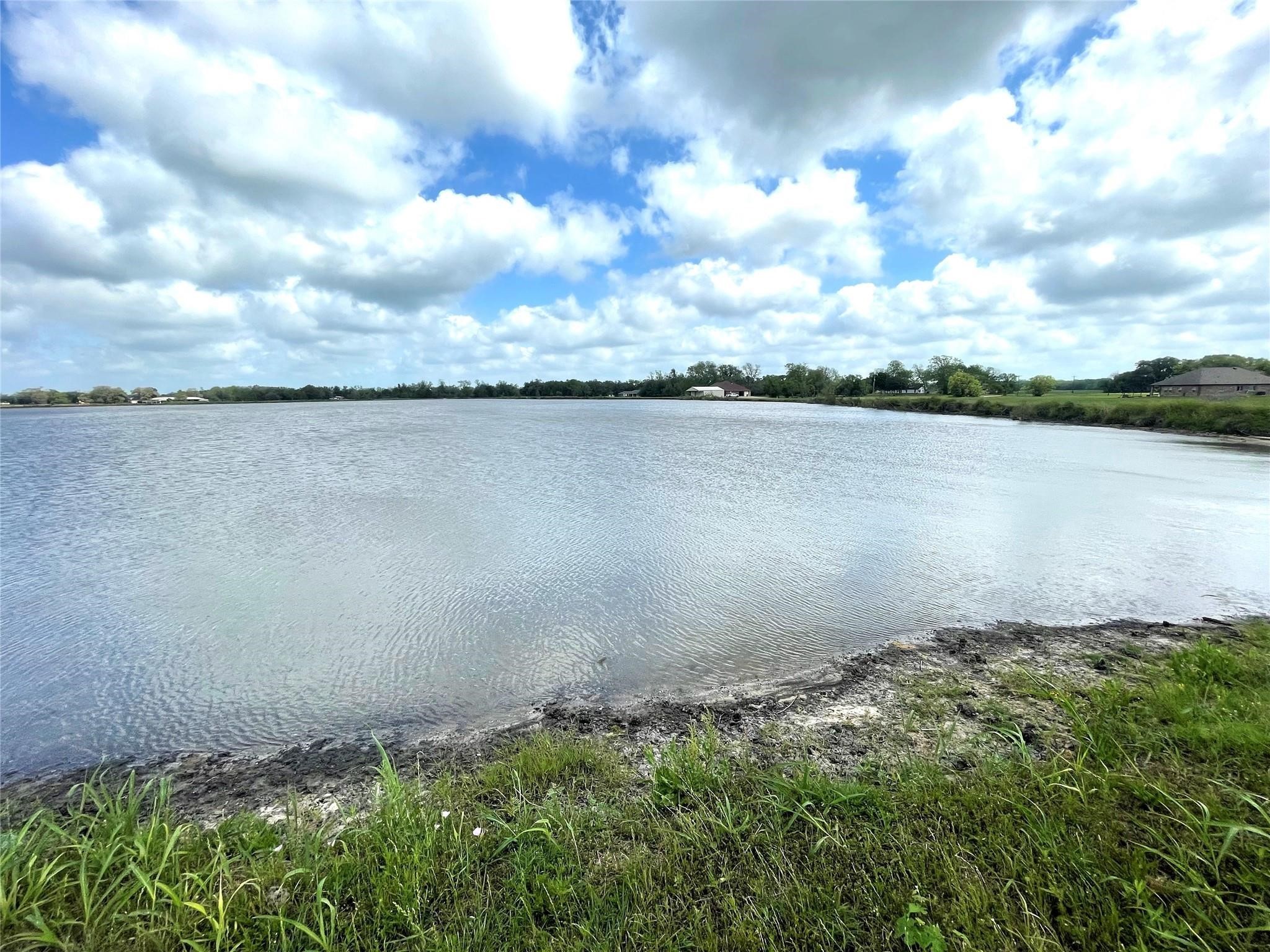 912 Wagon Wheel Trail Angleton, TX 77515 - Photo 8 of 11 a view of a lake from a yard