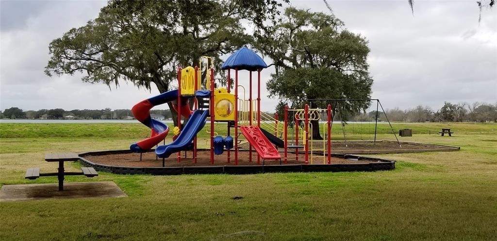 912 Wagon Wheel Trail Angleton, TX 77515 - Photo 10 of 11 a view of a park with swings and slides