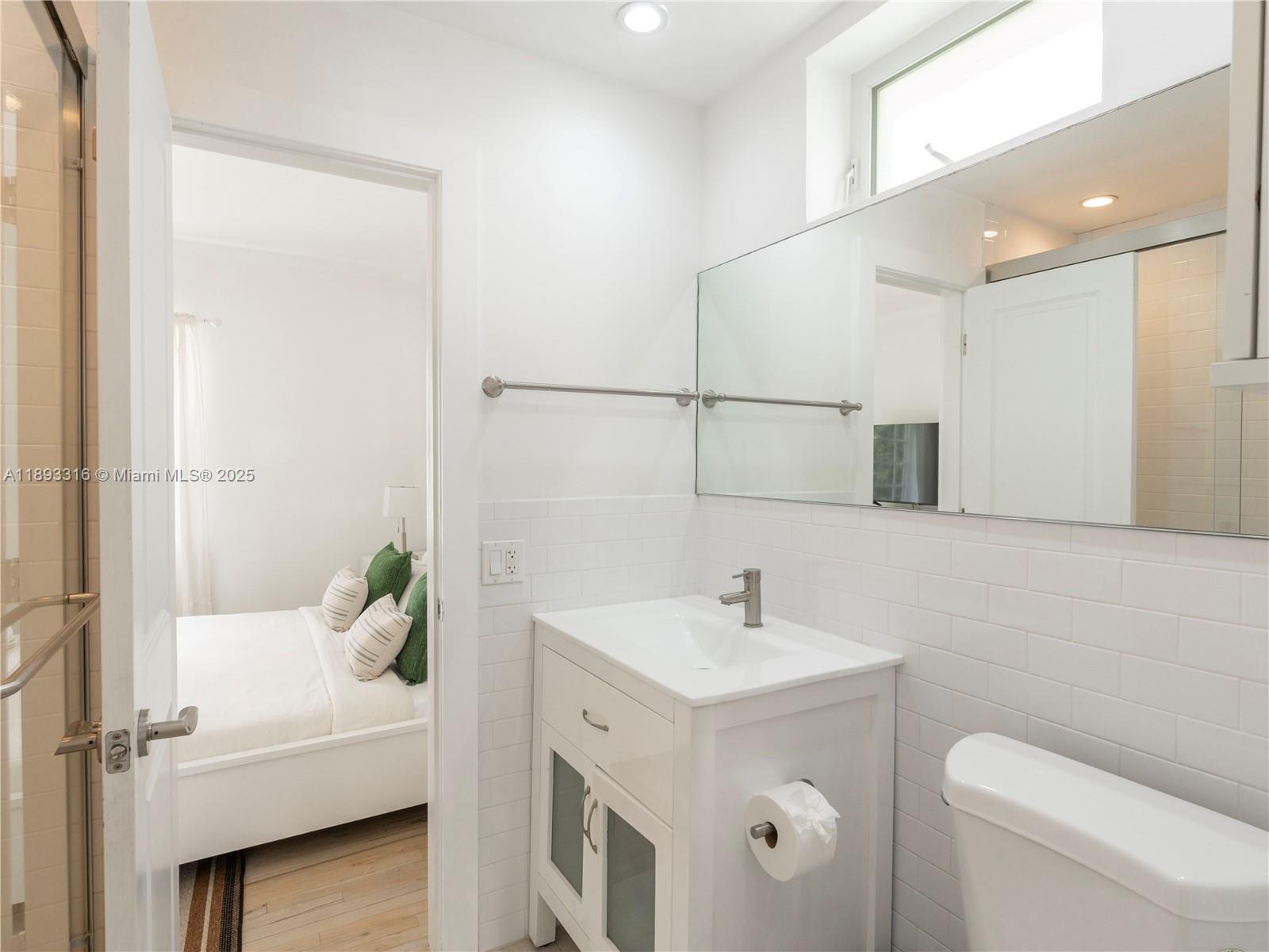 241 28th Street, Unit 1 Miami Beach, FL 33140 - Photo 11 of 16 a bathroom with a sink a toilet and shower