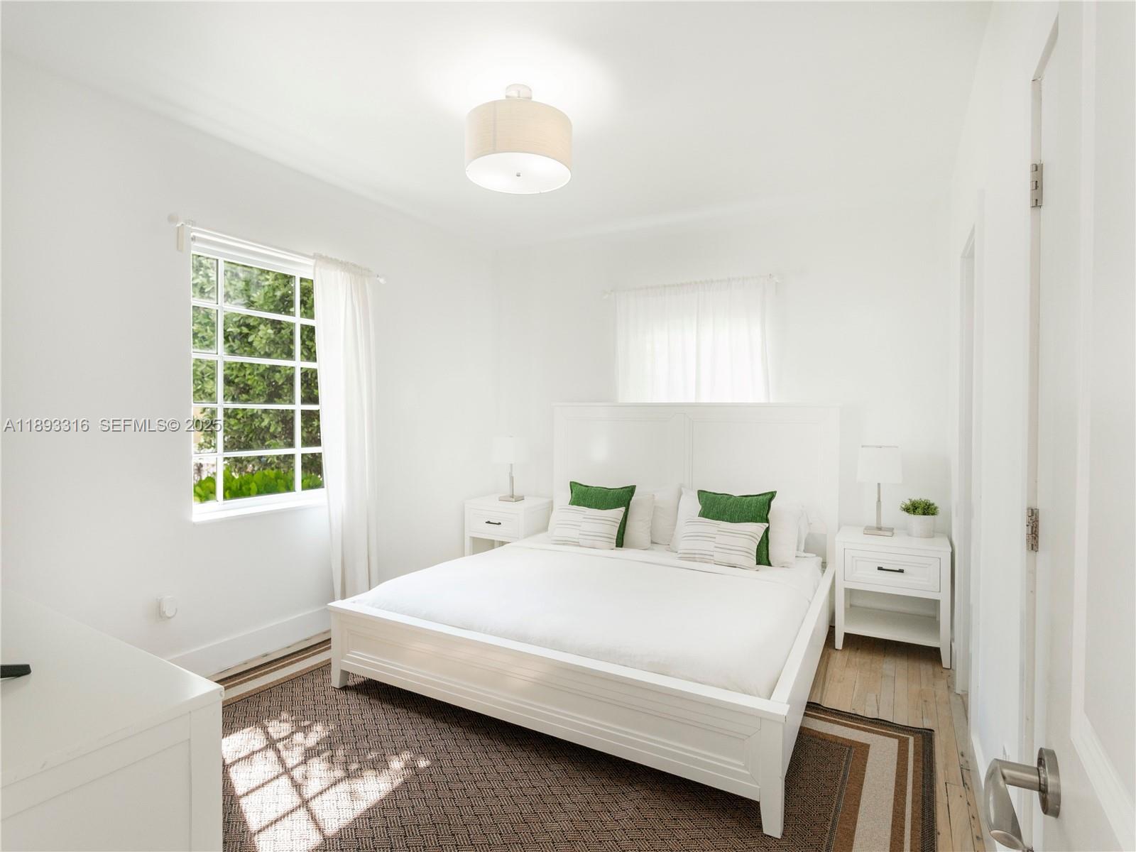 241 28th Street, Unit 1 Miami Beach, FL 33140 - Photo 14 of 16 a bedroom with a bed and a window