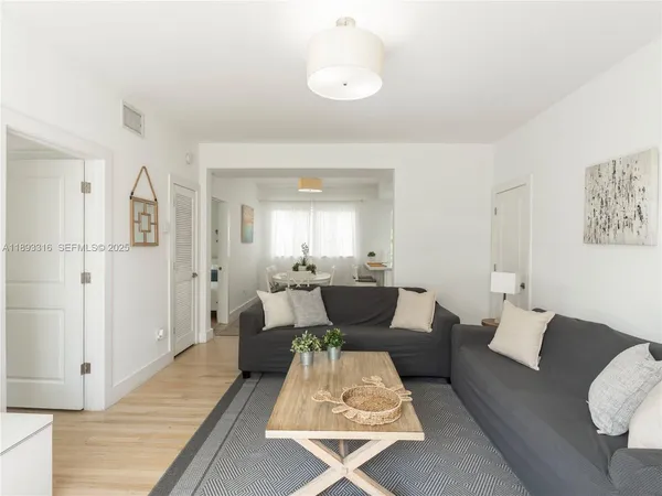 a living room with furniture rug and wooden floor