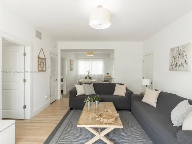 a living room with furniture rug and wooden floor
